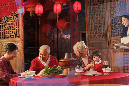 孩子吃饭幸福的东方家庭准备过年吃团圆饭背景
