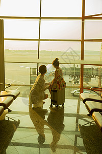 妈妈背影年轻妈妈和女儿从机场候机厅往外看背景
