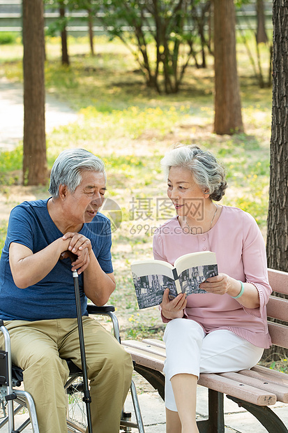 老年夫妇坐在公园里看书图片