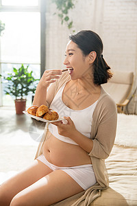 孕妇饮食孕妇正在吃面包背景