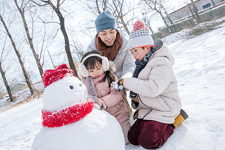 爸爸和孩子们推雪人图片