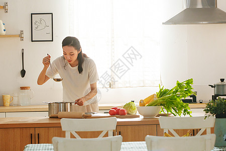 青年女人在厨房里做饭图片