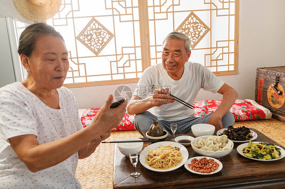 老年夫妇在家里吃饭看手机图片