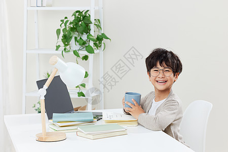 书桌前上网课的小男孩图片