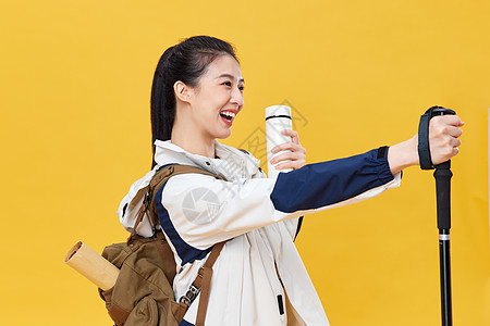 户外登山徒步登山带保温杯的青年女子背景