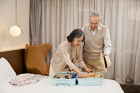 养老度假旅行的老年夫妻使用行李箱整理背景