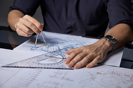 室内施工建筑设计师在桌上画图特写背景