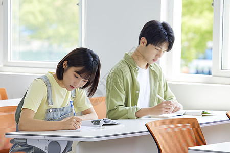 男孩写作业大学生教室自习做题背景