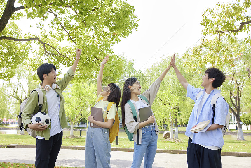 大学生们校园里击掌庆祝图片