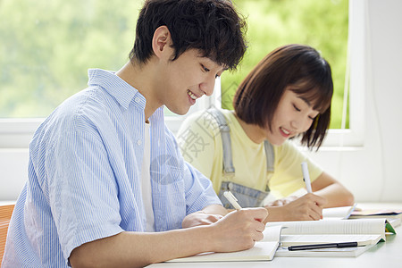 低头美女青年大学生低头书写背景