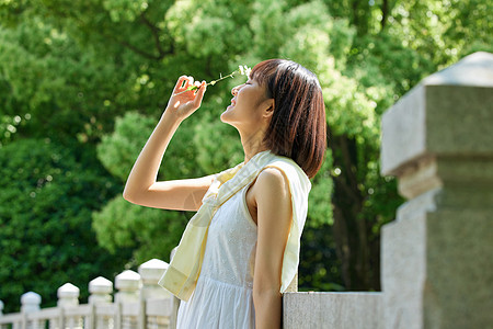 户外公园女性手拿花朵图片