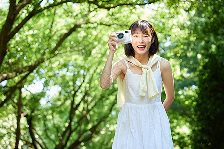 可爱的照相机女生夏日外出散步用照相机拍照背景