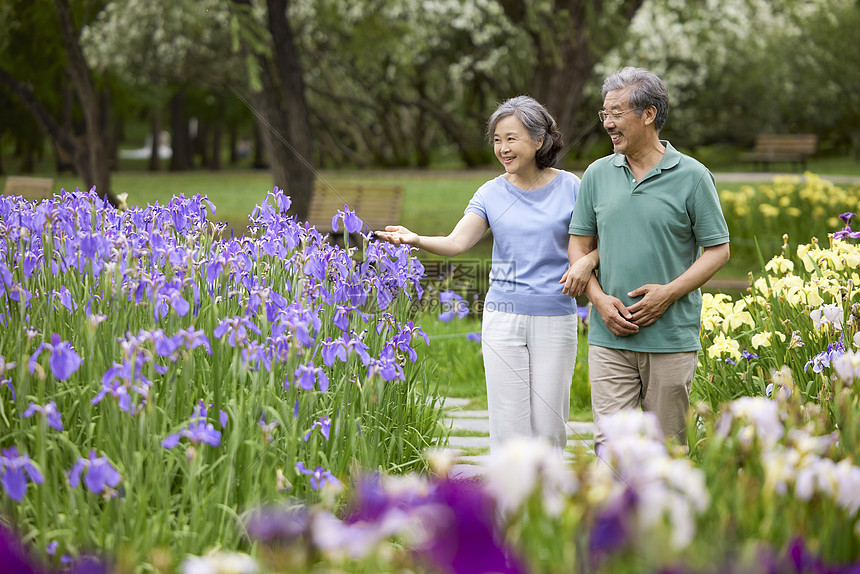 老年夫妇公园赏花散步图片