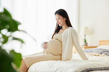 孕妇抚摸肚子待产孕妇妈妈居家养胎背景