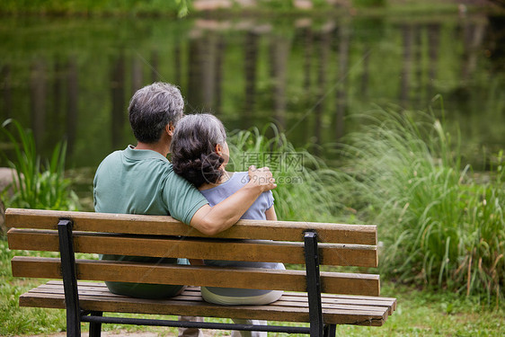 老夫妻坐在湖畔边长凳上图片