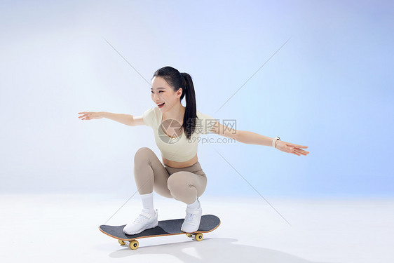 佩戴智能手环的女孩玩滑板图片