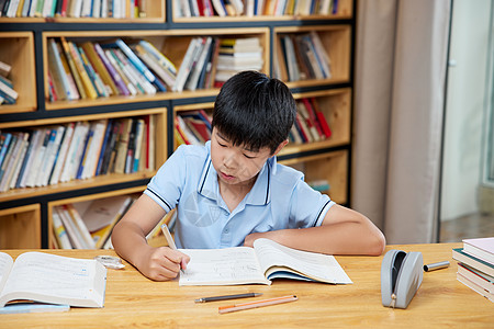 书桌前认真学习的男孩图片