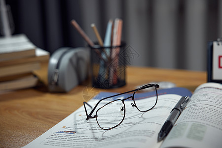 书本特写书桌上的眼镜特写背景