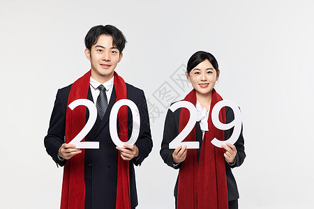 手拿数字2029的商务男女背景图片