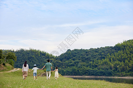 欧美母女一家人在草原上手拉手散步背景