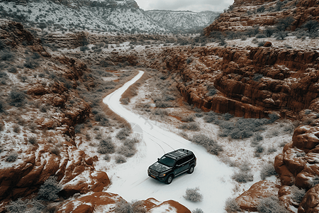 一辆黑色SUV驶过积雪覆盖的峡谷图片