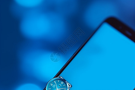 蓝色调下的手表和手机背景图片