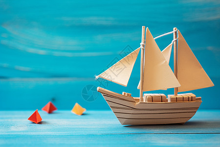 一艘纸帆船在蓝色背景中图片