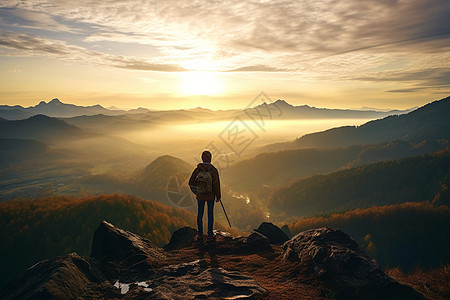 山顶眺望山顶夕阳中孤独的攀登者背景