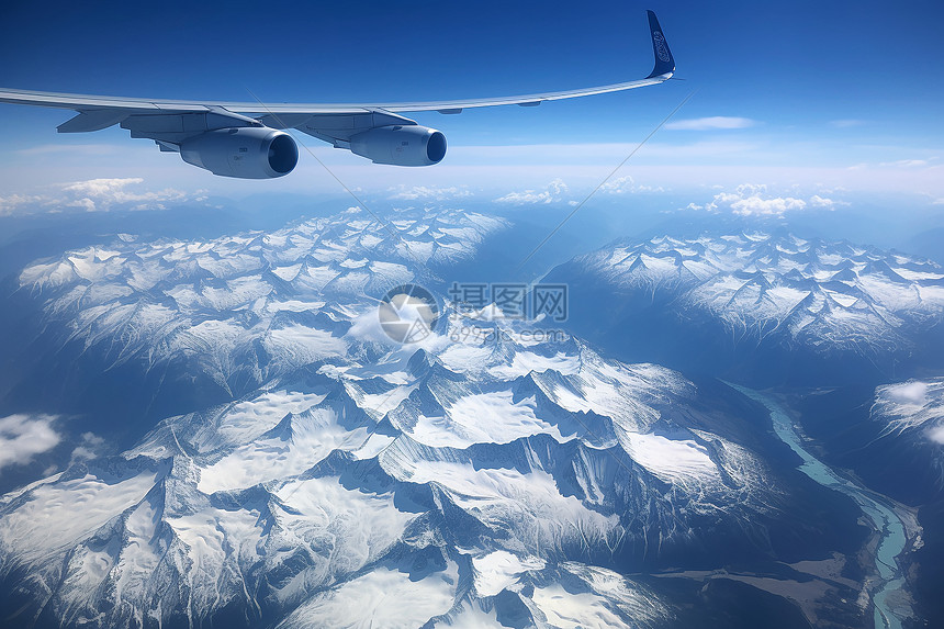 辽阔雪山山脉上空的飞机图片
