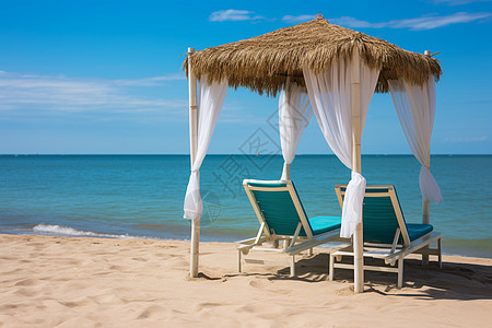 沙滩茅草棚下的度假椅图片