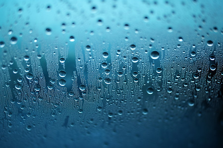 玻璃雨滴蓝色玻璃上的水滴背景