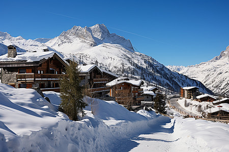 雪山村庄中的小木屋图片