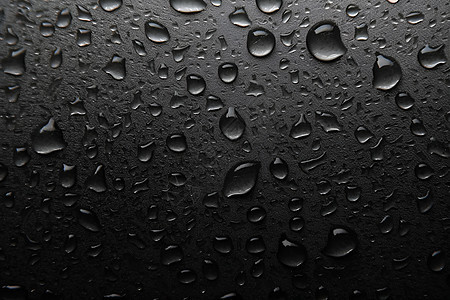 雨后黑色玻璃上的雨滴图片