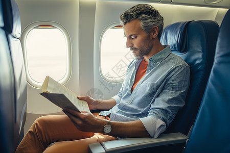 飞机上读书的男人高清图片