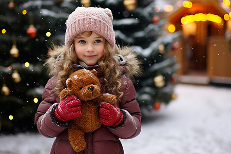 雪地里圣诞树前的女孩背景图片