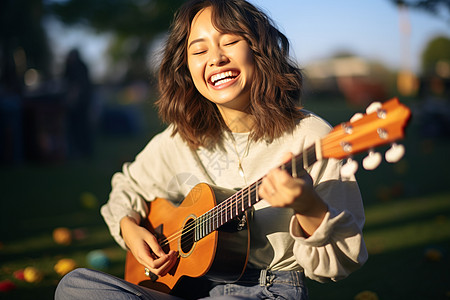 弹奏尤克里里的女孩高清图片