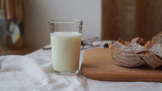 木板上的牛奶和面包切片牛奶杯和面包视频素材
