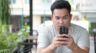 年轻英俊的超重亚洲男人在咖啡店放松mov格式视频下载_正版视频编号260874-摄图网