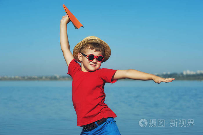快乐的男孩玩纸飞机在自然中.孩子们的活动
