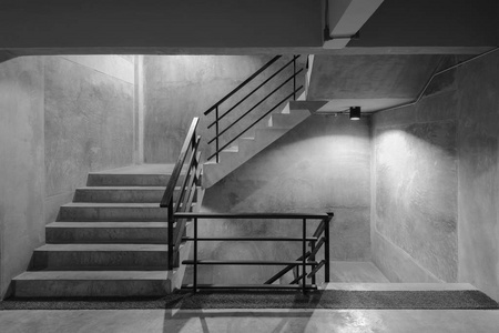 空现代粗糙混凝土楼梯与黑色钢扶手