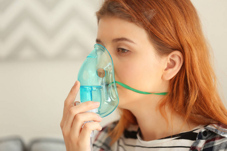 使用雾化器哮喘的年轻女人