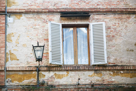 在锡耶纳的中世纪房屋的窗户附近的灯笼