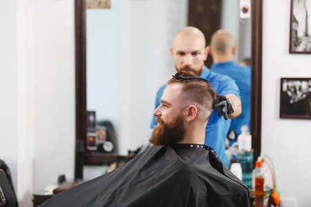 男专业美发师为客户提供理发服务。姜