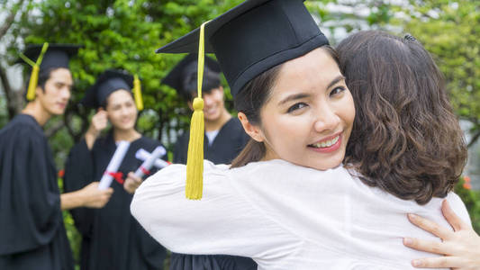 女学生的毕业服与帽子拥抱父在祝贺仪式