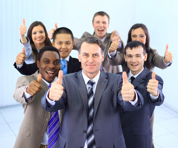 幸福的多民族商业团队在办公室竖起大拇指