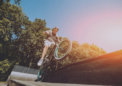 年轻的小轮车车手在 skatepark 表演把戏