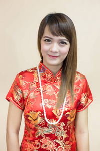 中国传统节日中的亚洲女性问候与珍珠旗袍在红色金色的春节庆典上的特写