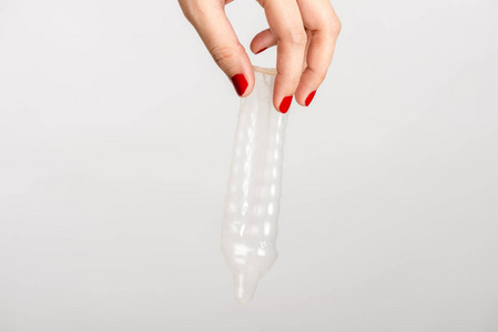 亚洲妇女手拿避孕套在白色背景上