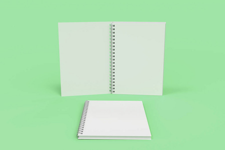与螺旋装订在绿色背景上的两个笔记本
