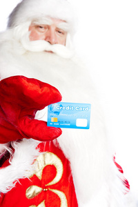 传统的圣诞老人持有信用卡，同时发放信用卡